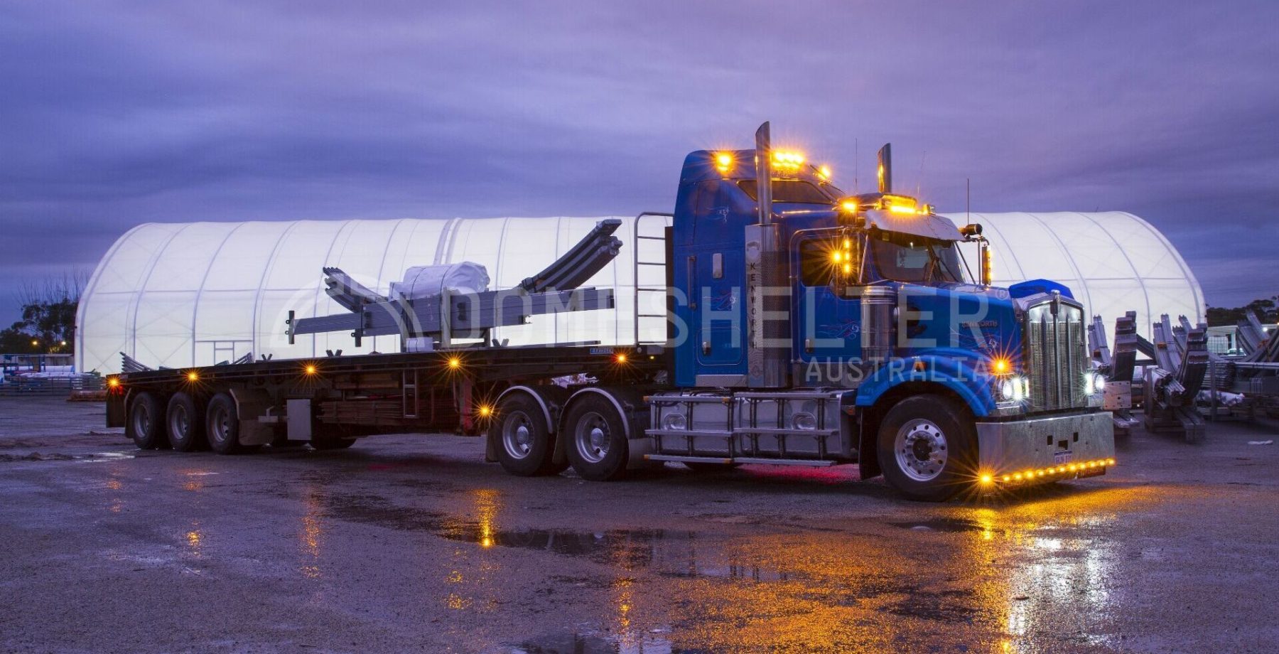 Truck parked in the rain in front of a Post Mounted Dome Fabric Structure